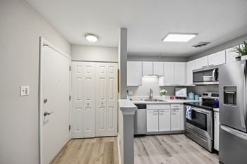 Hardwood floored kitchens with plenty of counter space and cabinets
